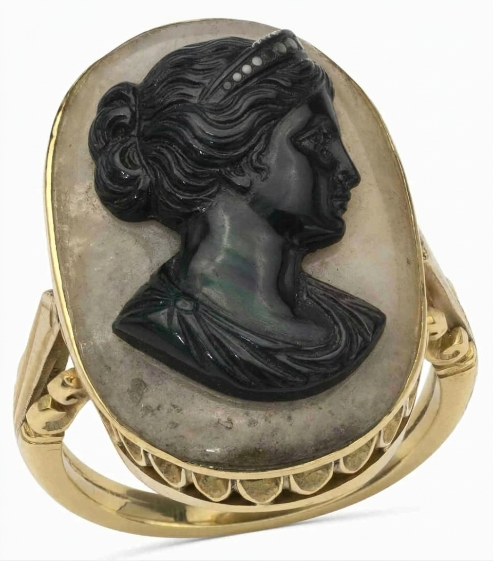 Estimation bague camée : profil féminin noir à diadème de petits points blancs sur fond gris clair, monture or